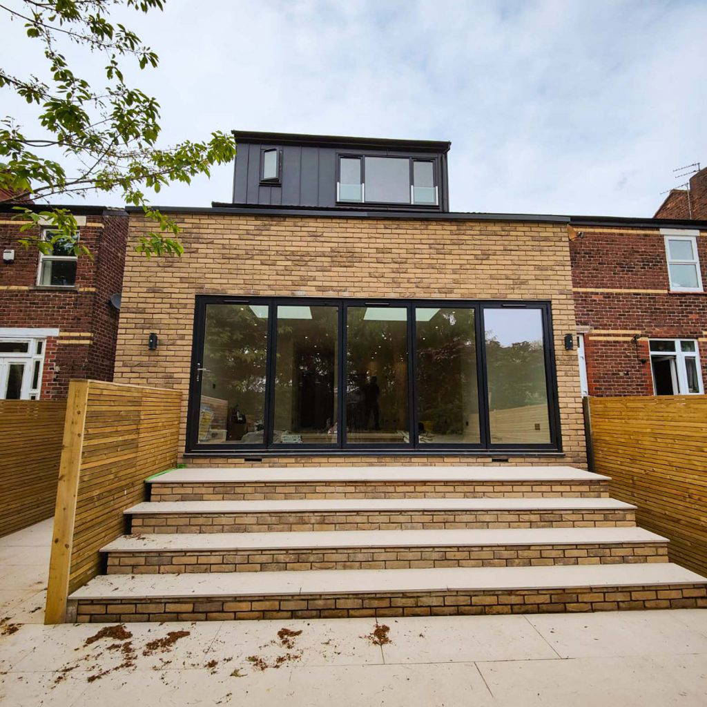 A striking, newly completed luxury detached new build home in Stockport featuring high-spec brickwork and modern glazing.