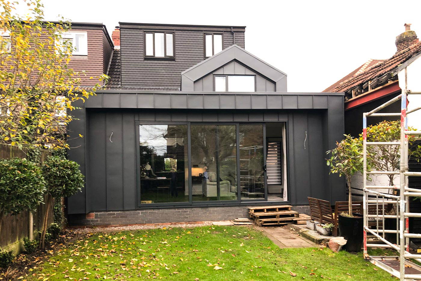 An external view of a seamless rear dormer loft conversion on a semi-detached house in Manchester.